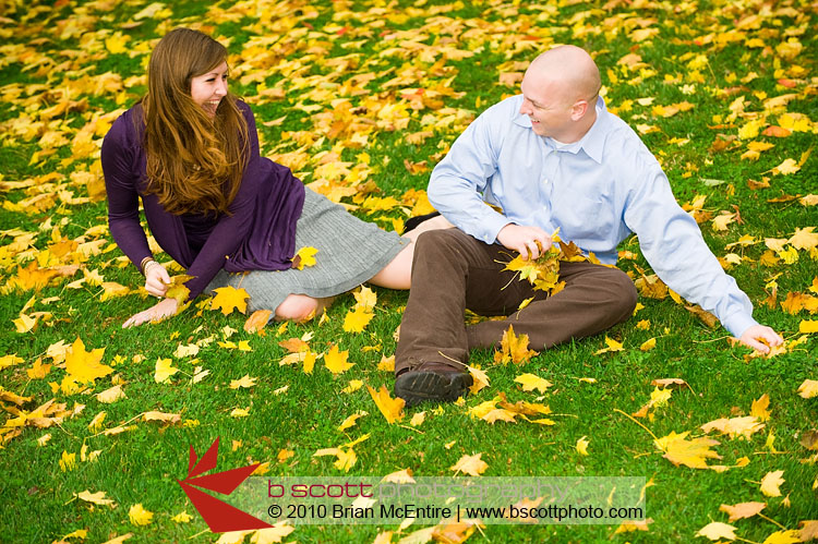 Playing in Leaves: Fiance gathers up leaves and is about to throw them at his significant other.