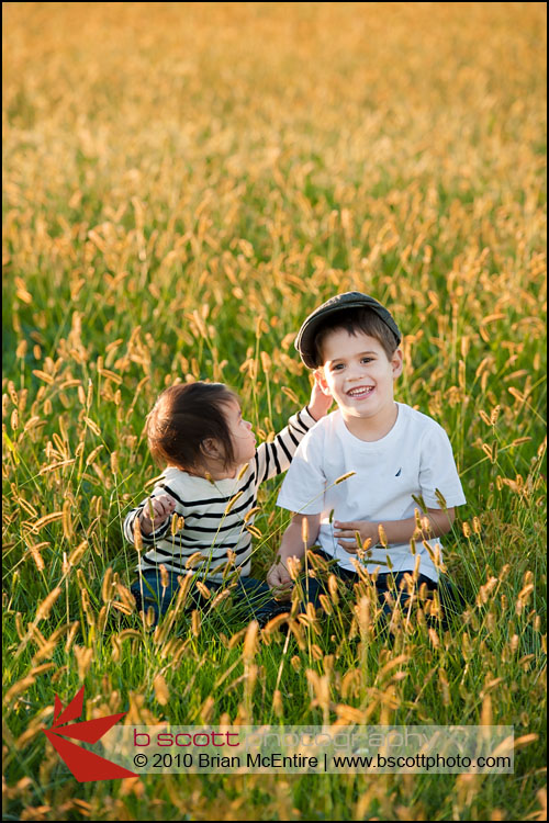 Two young children play in a beautiful field at sunset in Frederick, MD.