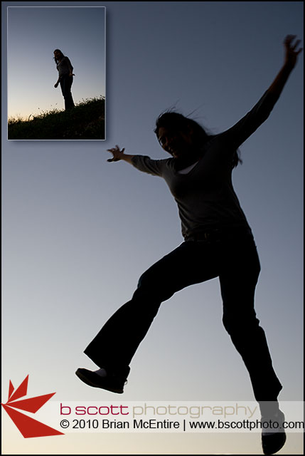 Young woman captured in silhouette against a deep blue sky.