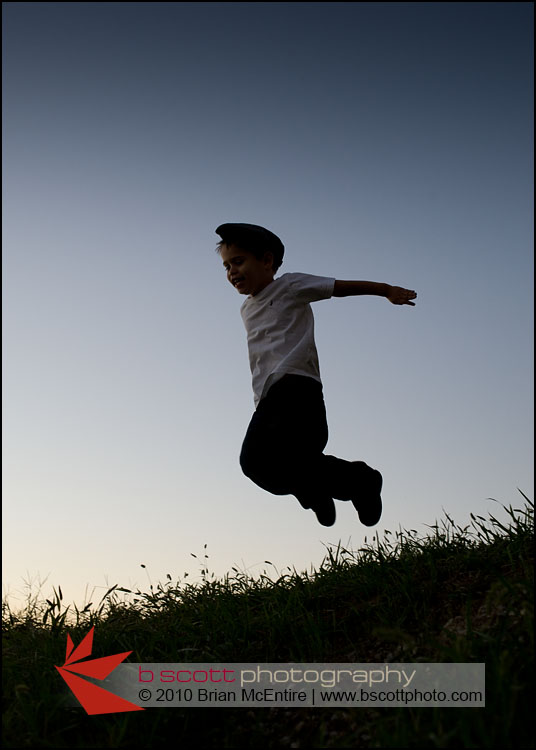 Photo: Silhouette of a young by jumping, set against the last deep blue color of an evening sky.