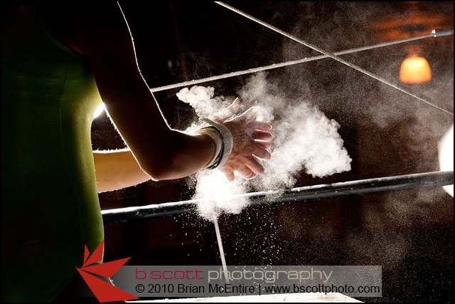 Chalk Powder Flies As Female Gymnast Preps for Bars