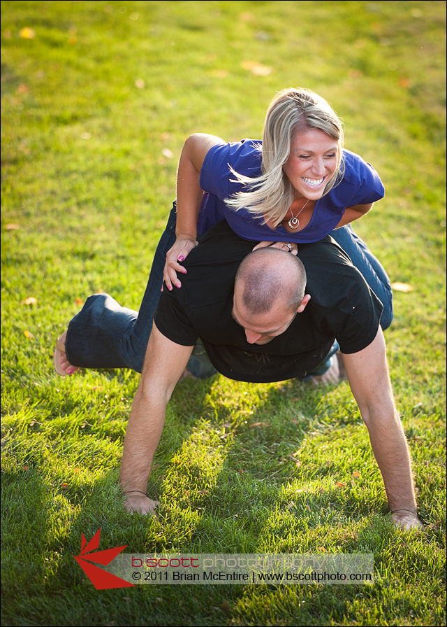 Happy young couple roughhousing outdoors.