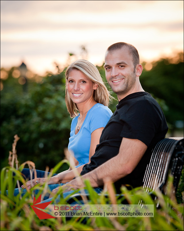 Handsome couple sits at bench in Baker Park, Frederick, MD during sunset.