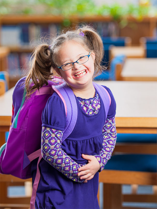 Girl Student with Down Syndrom in School Library